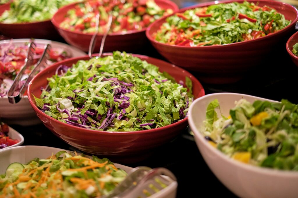 Vibrant salads with fresh veggies on display, shot close-up. The focus on fresh food caters to the
