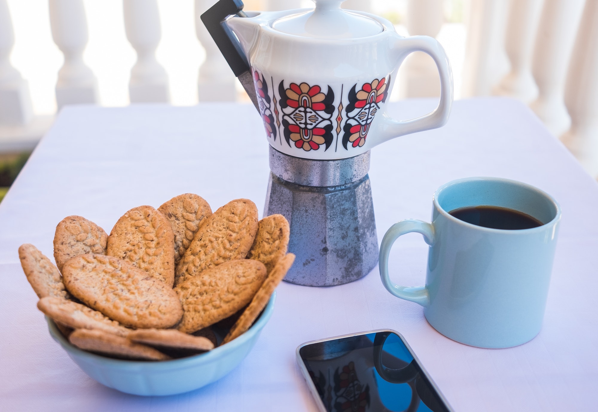 Breakfast or break outdoor on the balcony with coffe cup and whole grain biscuits