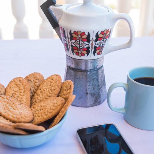 Breakfast or break outdoor on the balcony with coffe cup and whole grain biscuits