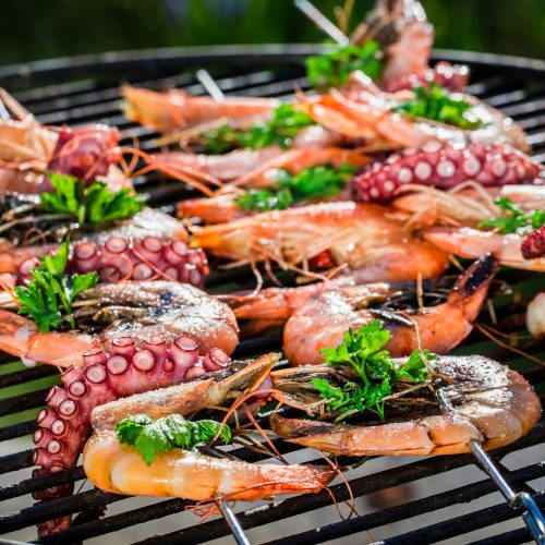 Fresh seafood skewers with lemon and parsley for grilling